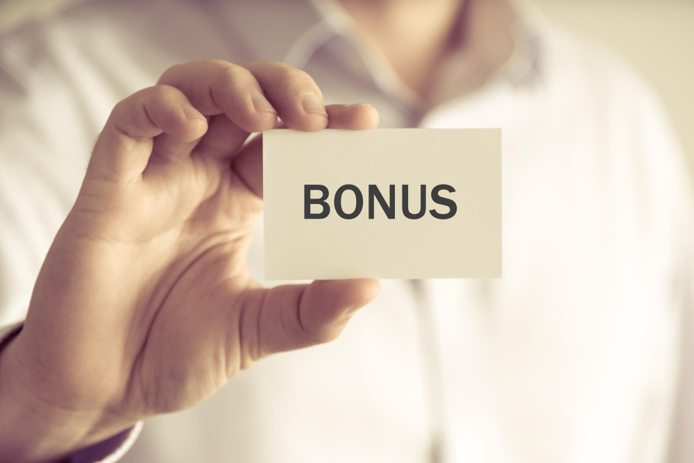 Man holding a card with the word bonus written on it